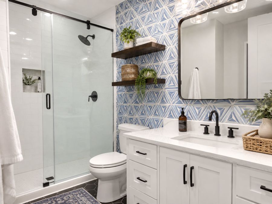 Bathroom wall with geometric peel-and-stick wallpaper creating pattern interest