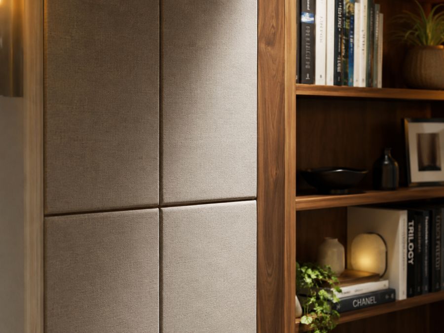 Close-up of acoustic foam panels and a fabric-wrapped sound-absorbing panel mounted on a bedroom wall