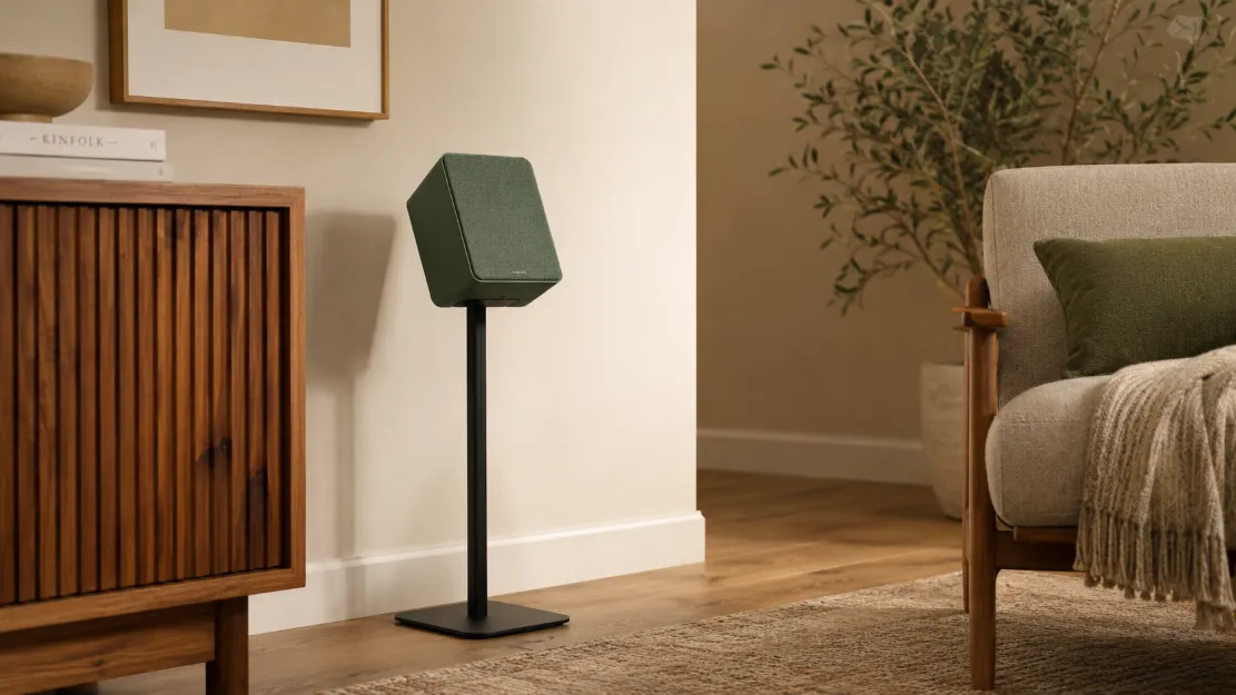 Compact speaker placed on a stand away from the wall and angled toward the listener